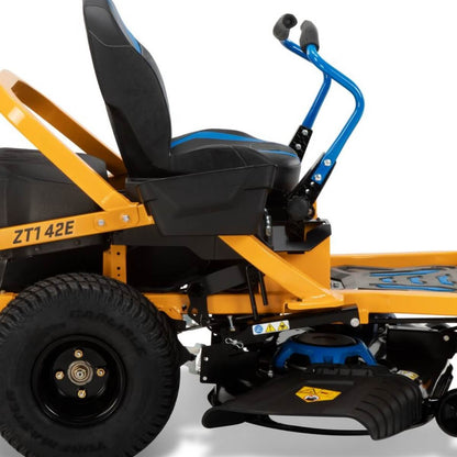Close-up view from the side of a yellow Cub Cadet ZT1 ride on lawn mower with black seat and blue handle on a white background.