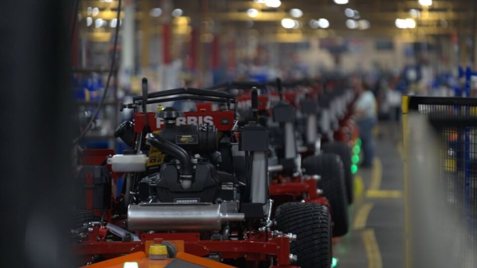 Looking down the production line of Ferris 300S red ride on mowers.