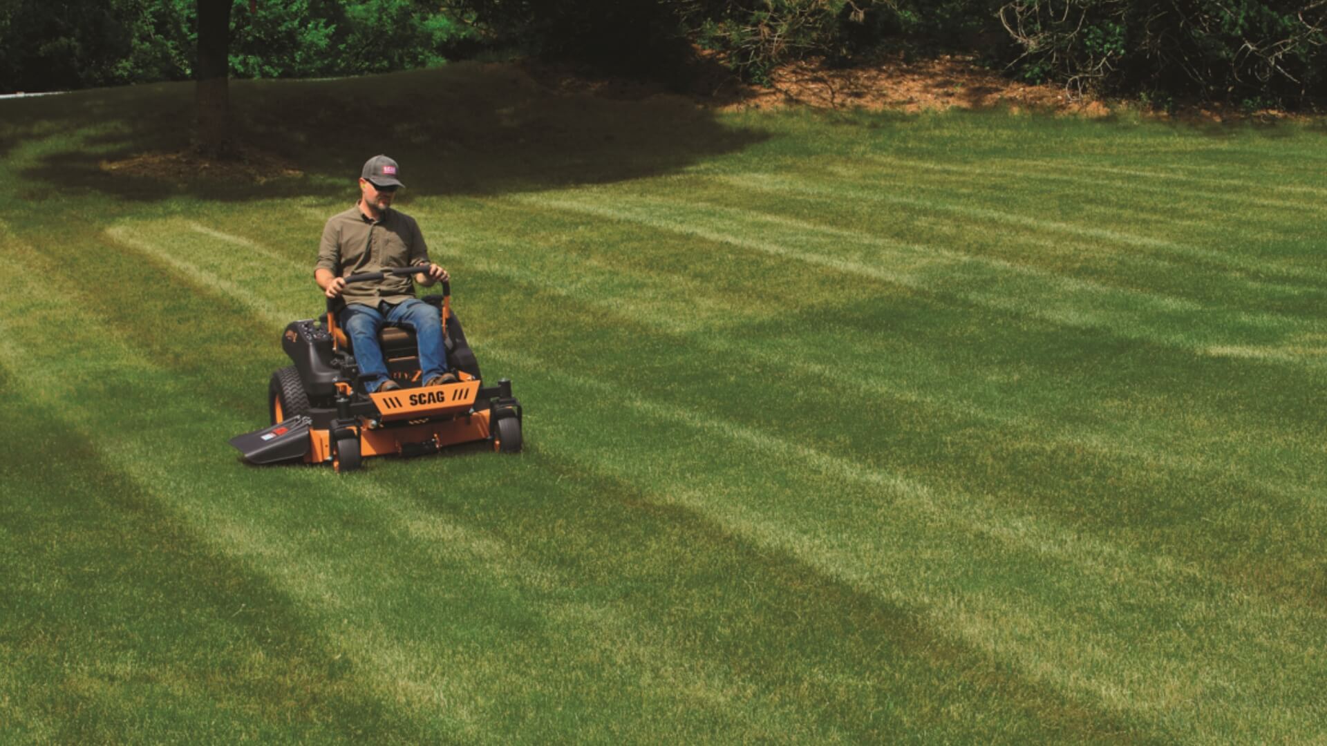 Load video: Man operating the Scag liberty z ride on mower across his green lawn