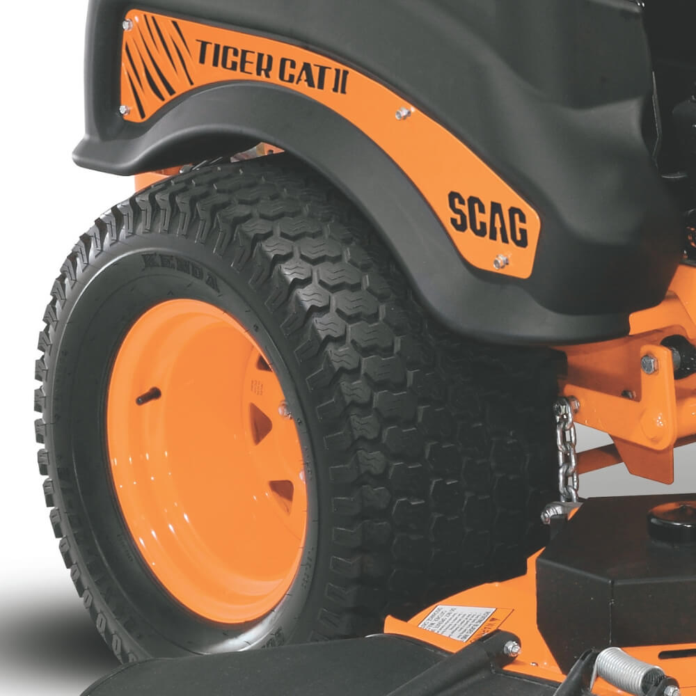 Close-up of an orange and black SCAG Tiger Cat II lawn mower tire on a white background