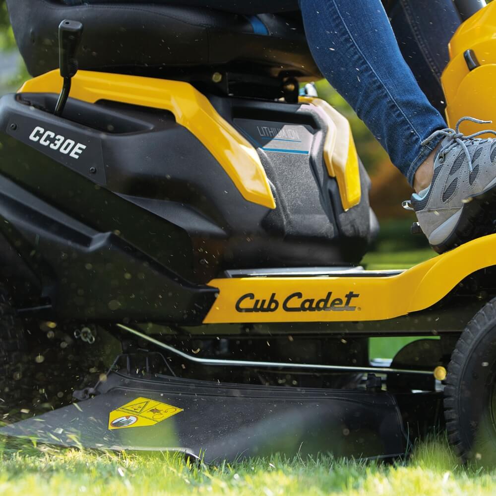 Person using a Cub Cadet CC 30E lithium powered electric lawn mower on grass