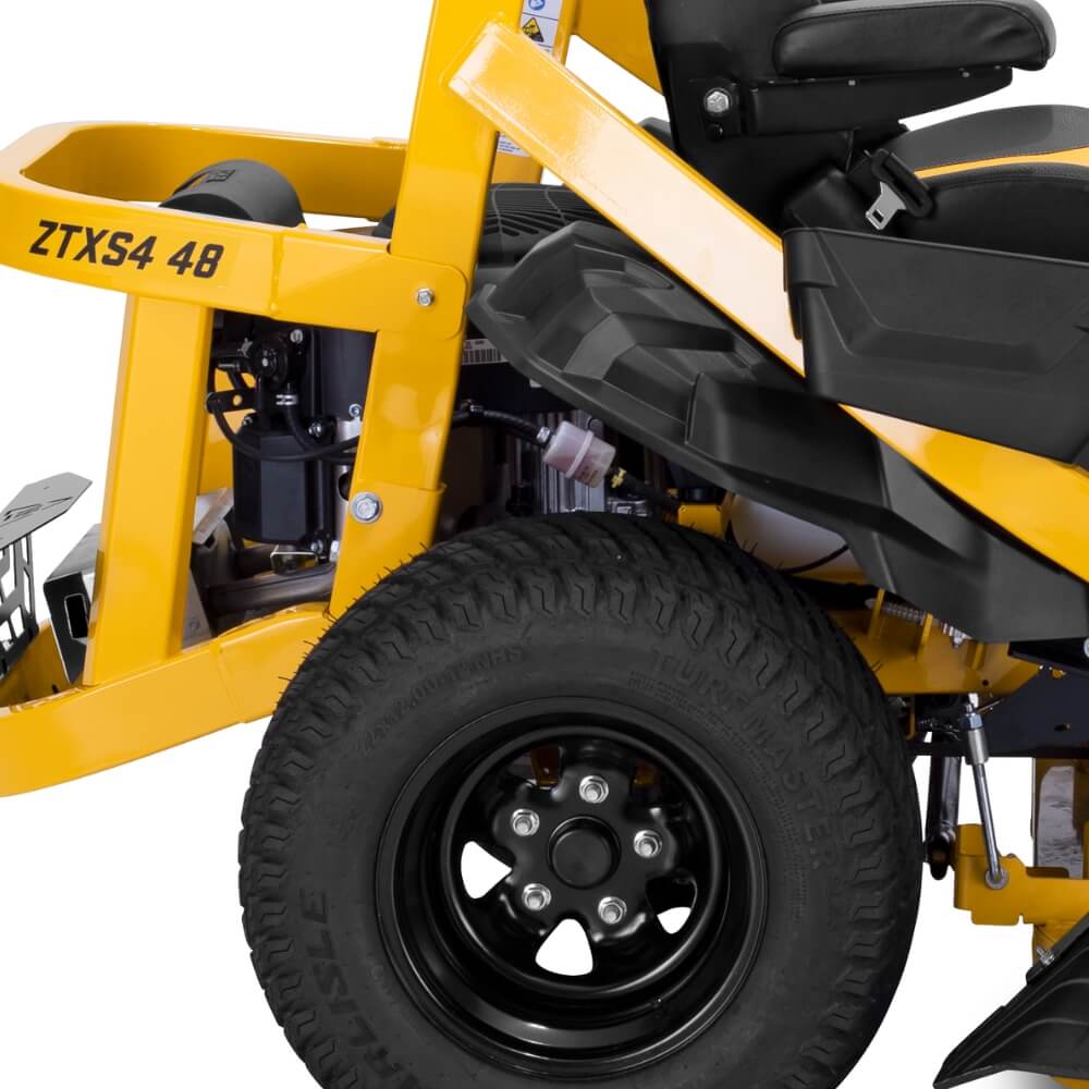 Close-up of a yellow ZTX S4 lawn mower with a black tire on a white background