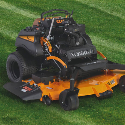 Orange and black lawn mower on a grassy background